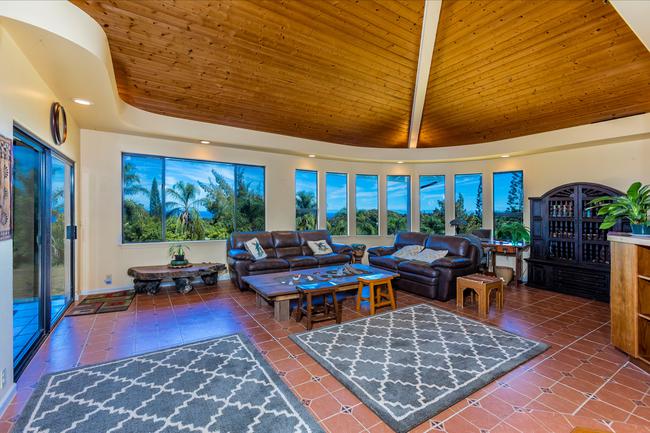 Living room with high vaulted ceilings.